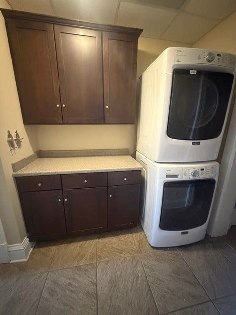 A white oven and microwave are stacked on top of each other.