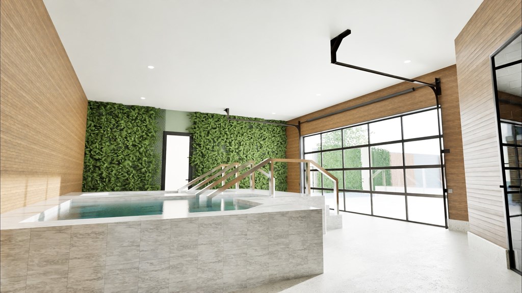 A modern interior with a green wall and a hot tub.