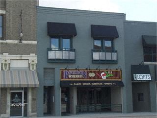 A building with a striped awning and a sign that says "Lofts".