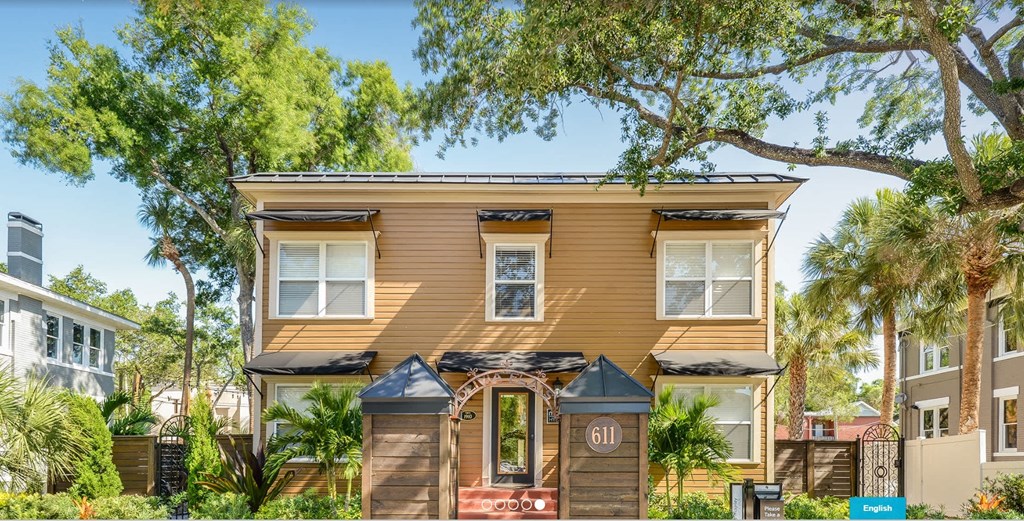 A house numbered 611 is surrounded by greenery.