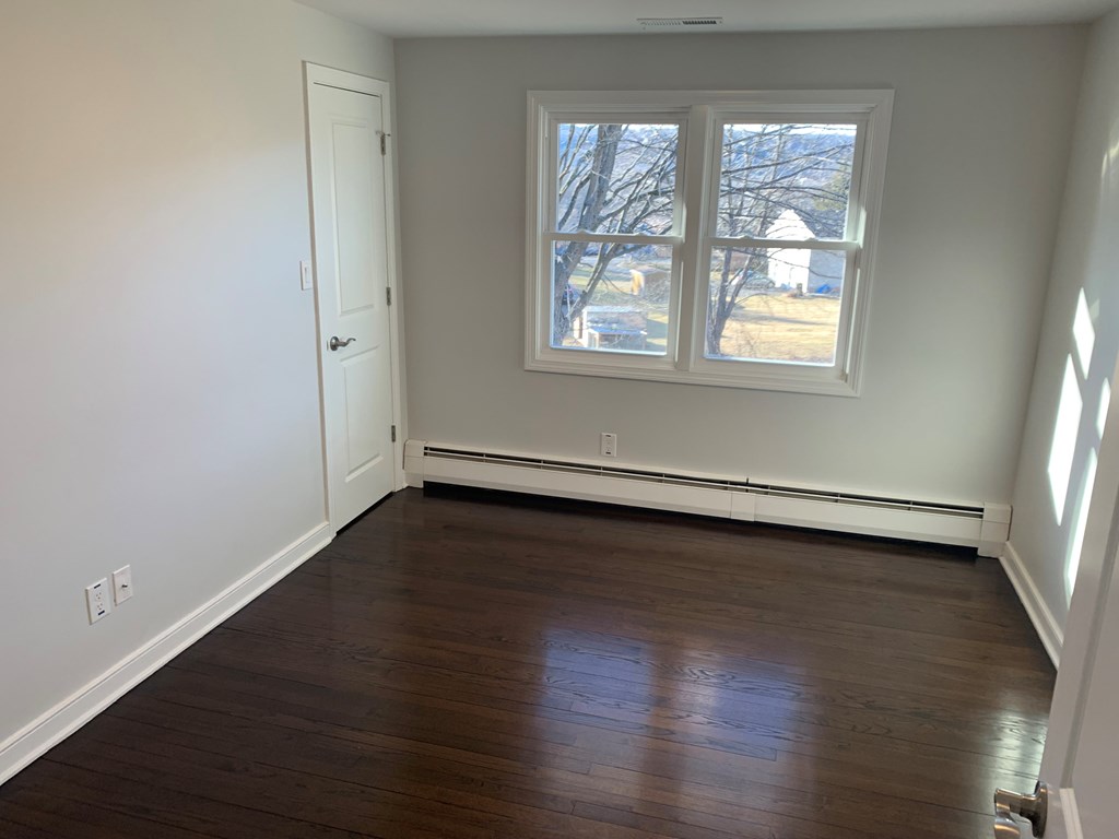 A room with a window and a door.