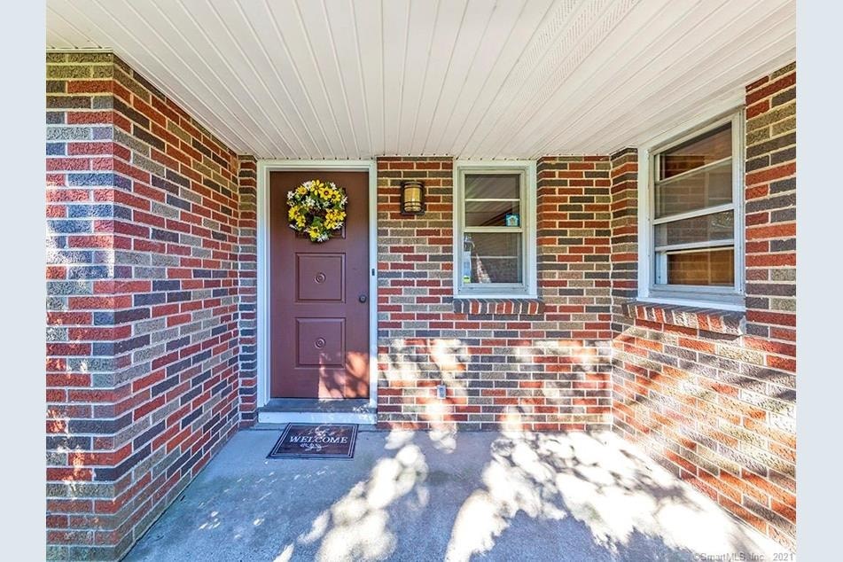 A red door with a wreath on it.