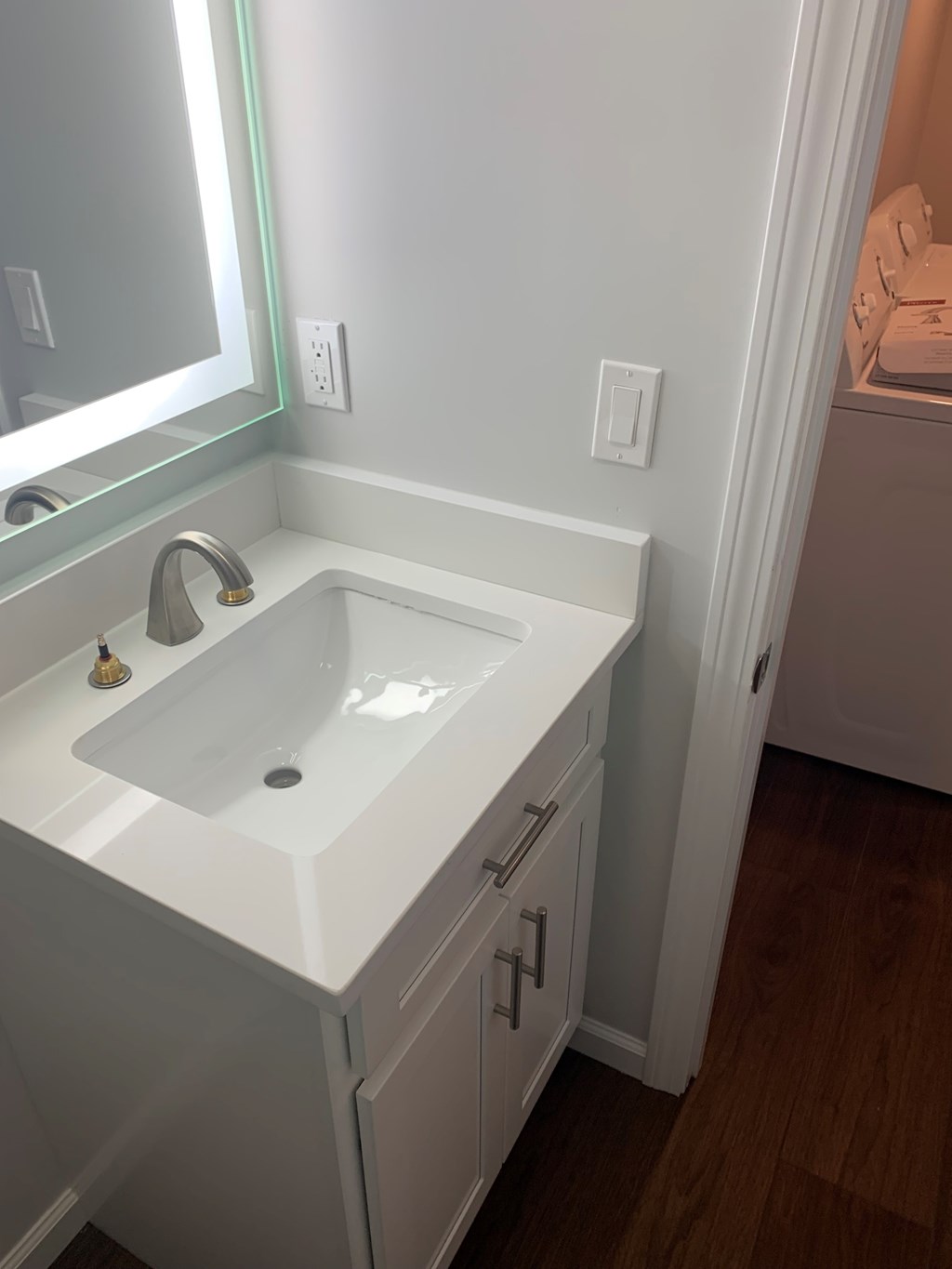 A white sink in a small bathroom.