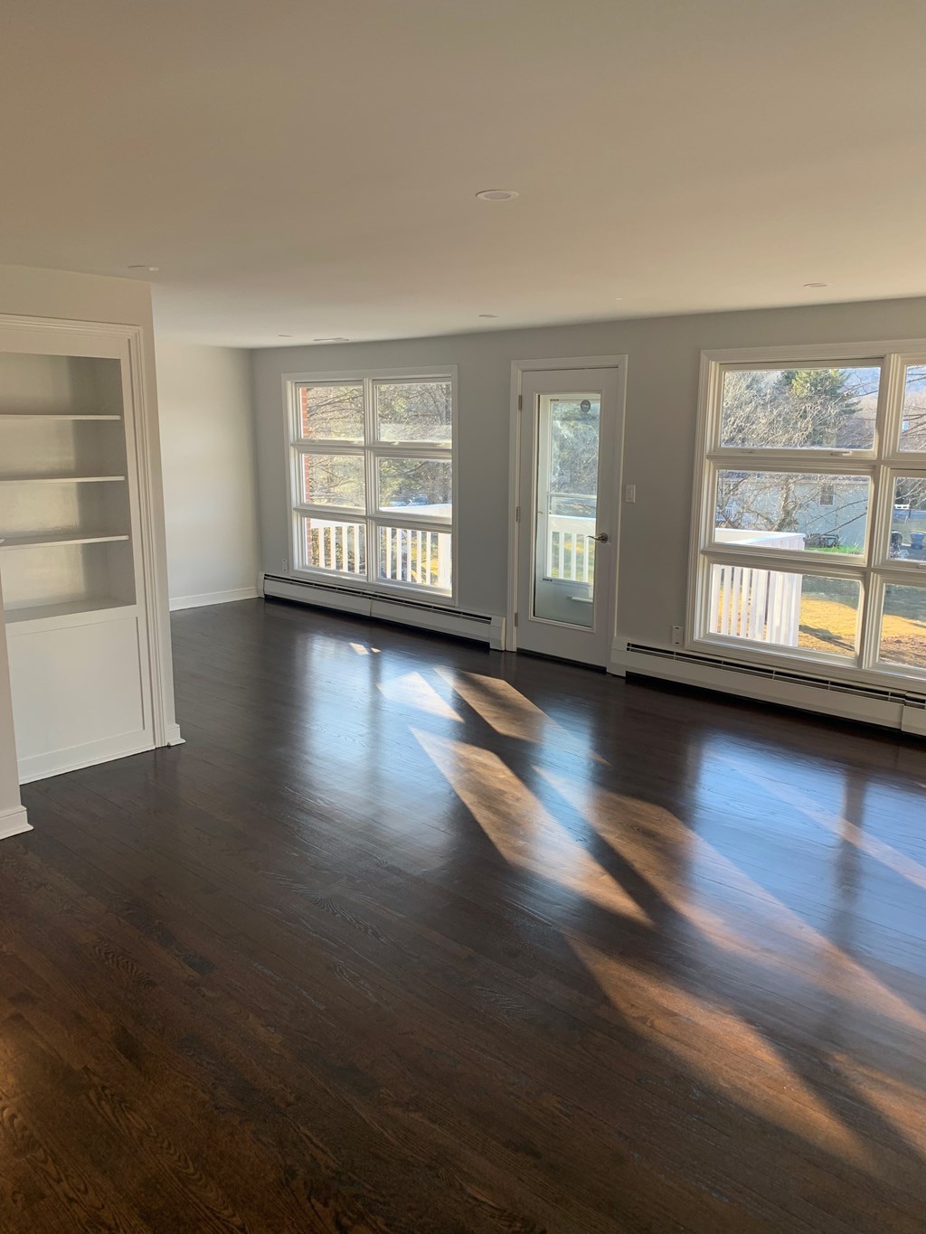 A room with wooden floors and white walls.