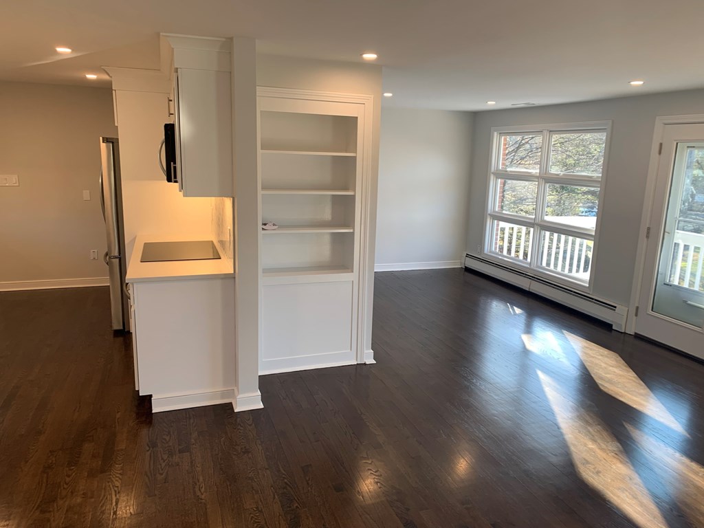 A room with a white cabinet and a window.