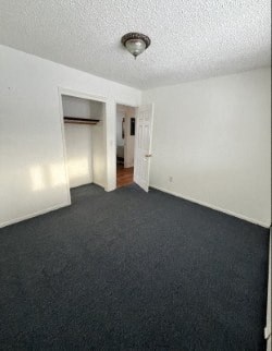 A room with a carpeted floor and white walls.