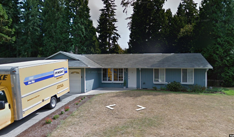 A house with a Pest Control van parked in front.