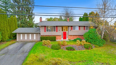 A house with a red door and a grey roof.