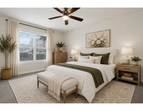 A bedroom with a large bed and a ceiling fan.