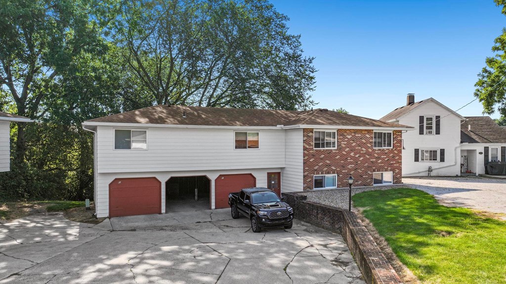 A house with a black car parked in front.