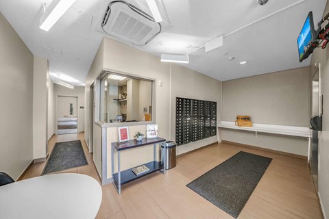A room with a white reception desk and a mirror on the wall.
