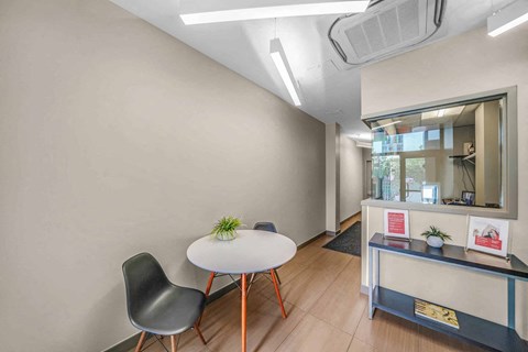 A room with a white table and a black chair.