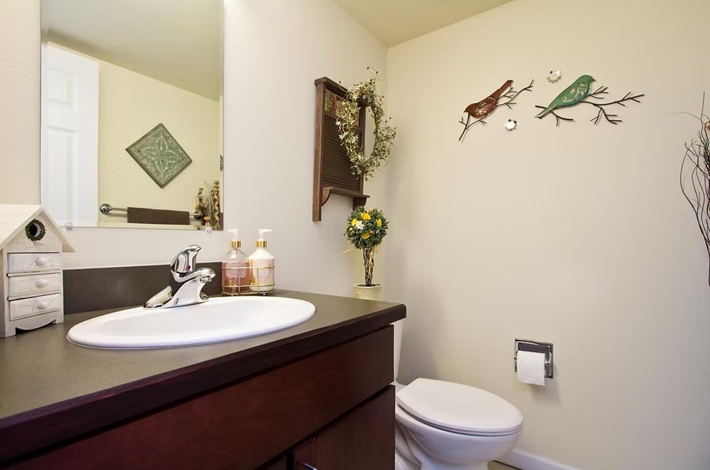 A bathroom with a white sink and toilet.