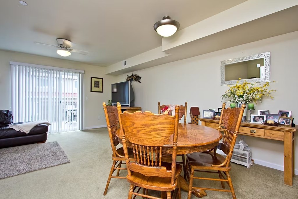 A dining room with a table and chairs.