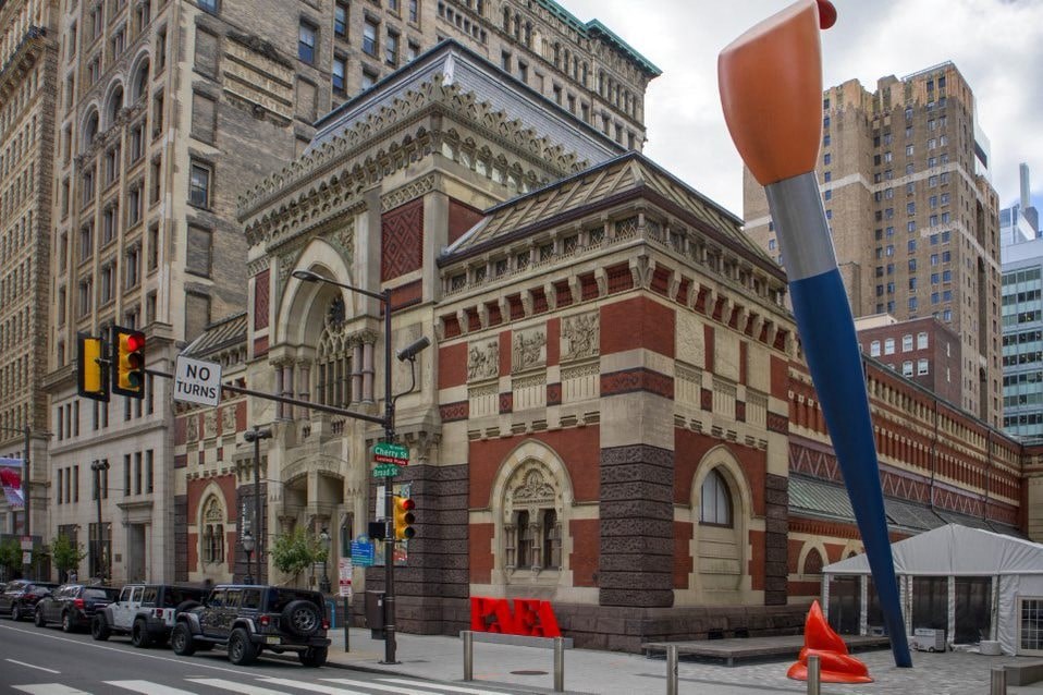 A large building with a red and white striped facade.