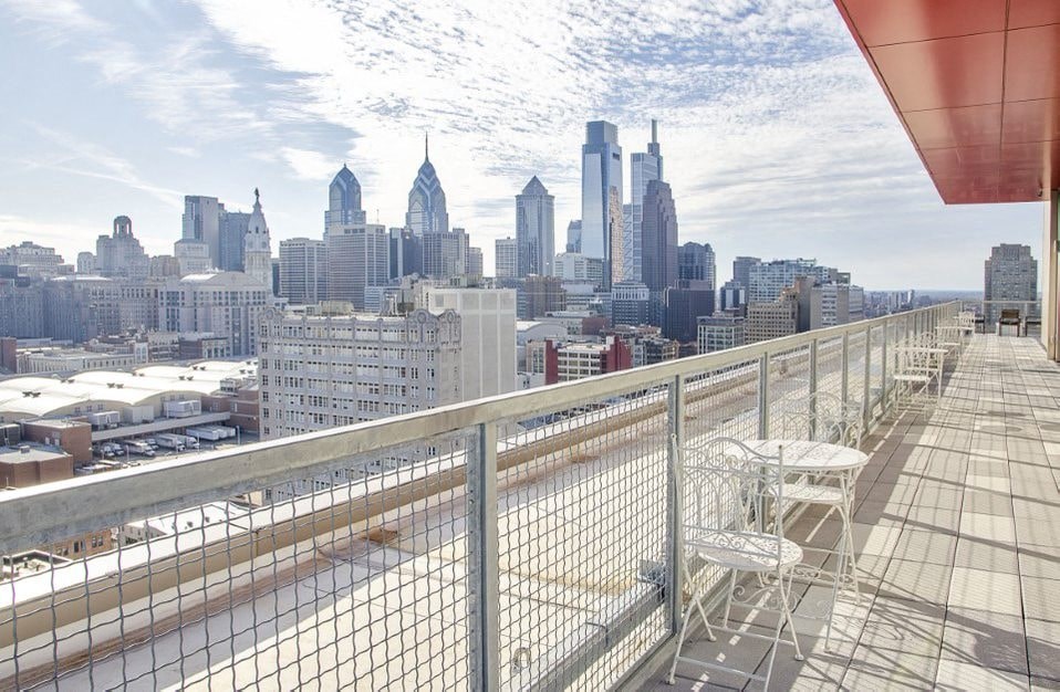 A cityscape with a balcony overlooking the buildings.