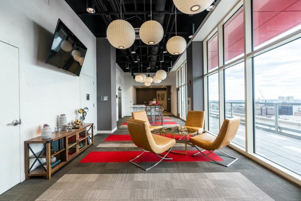 A modern office space with a long table and chairs.