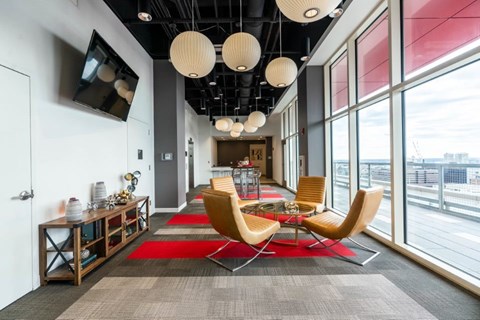 A modern office space with a long table and chairs.