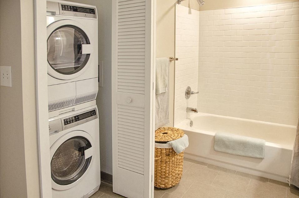 A white washing machine and dryer in a small laundry room.