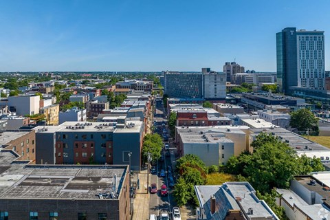 A cityscape with buildings of various sizes and a clear blue sky.
