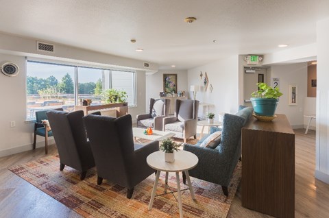 A living room with a round table and chairs.