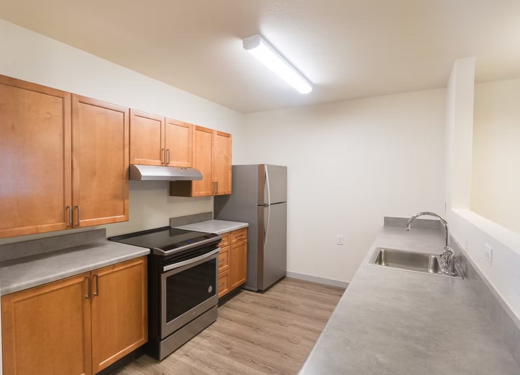 A kitchen with wooden cabinets and stainless steel appliances.