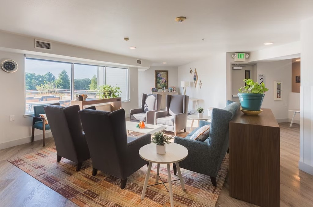 A living room with a round table and chairs.