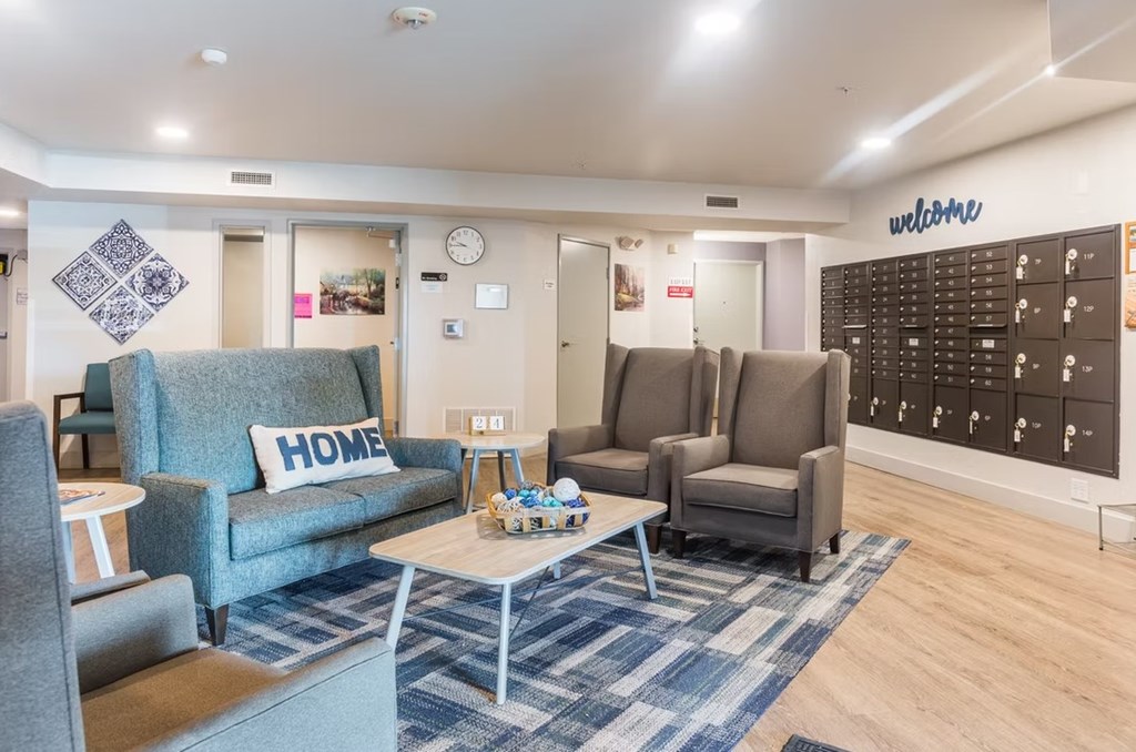 A living room with a sofa, chairs, and a coffee table.