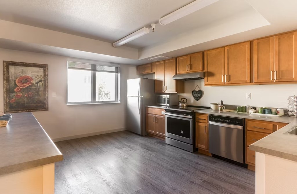 A kitchen with wooden cabinets and stainless steel appliances.