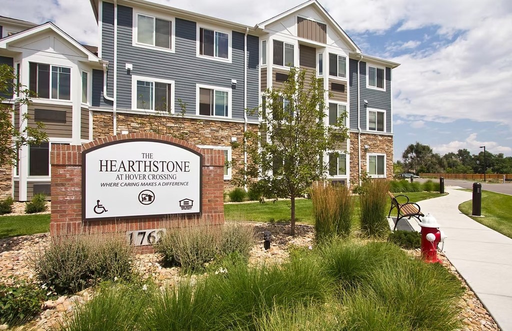 The Hearthstone apartment complex has a sign with the number 1762 on it.