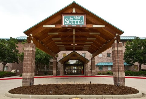 The entrance to a hotel named The Suites.