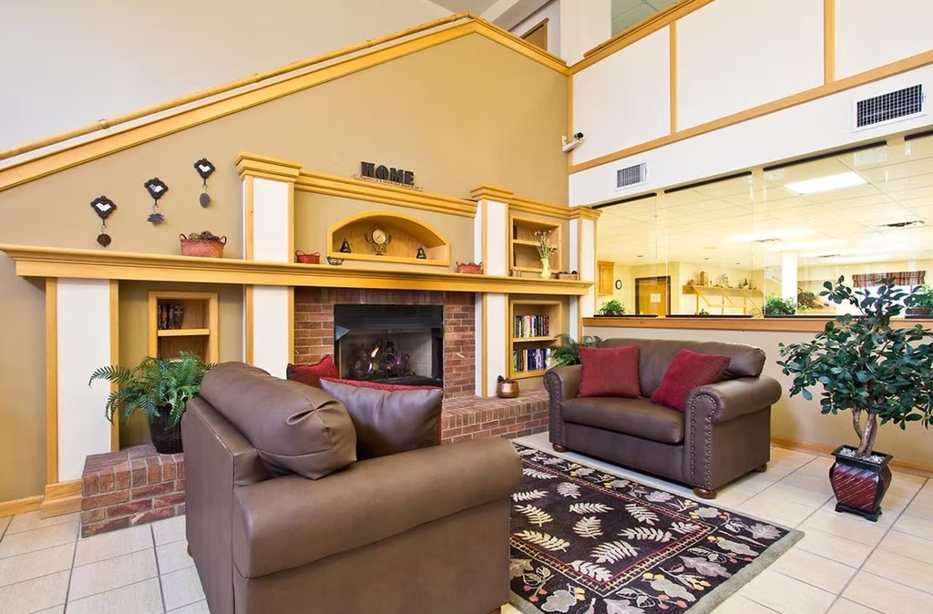 A living room with a fireplace and two couches.