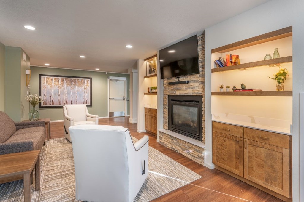 A living room with a fireplace and a television.