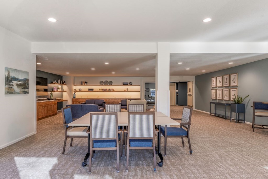 A conference room with a long table and chairs.
