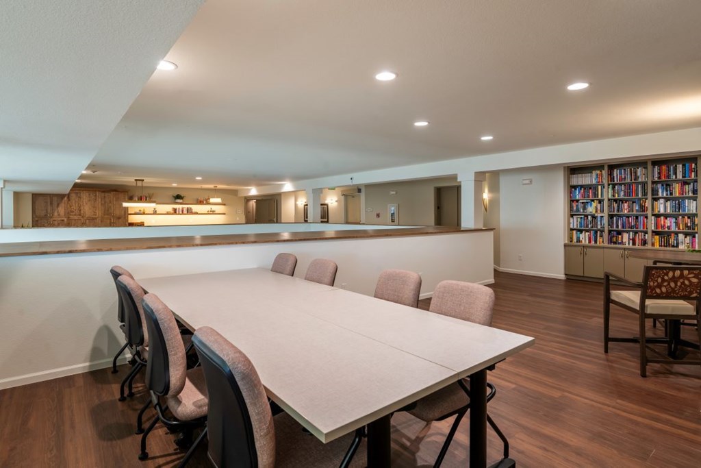 A conference room with a long table and chairs.