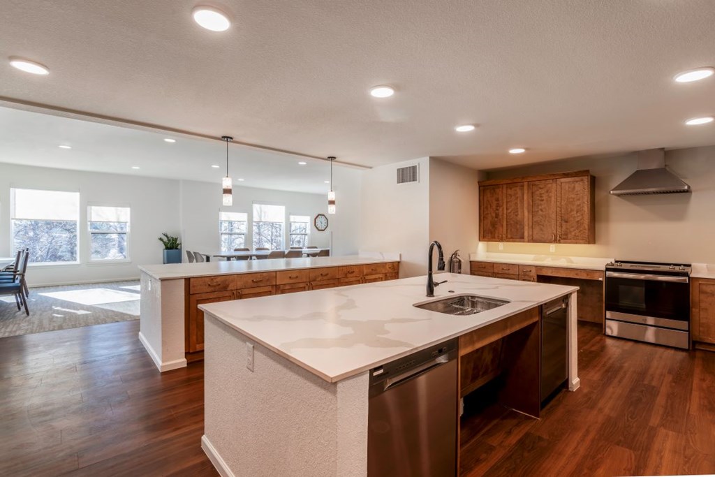 A modern kitchen with a large island and stainless steel appliances.