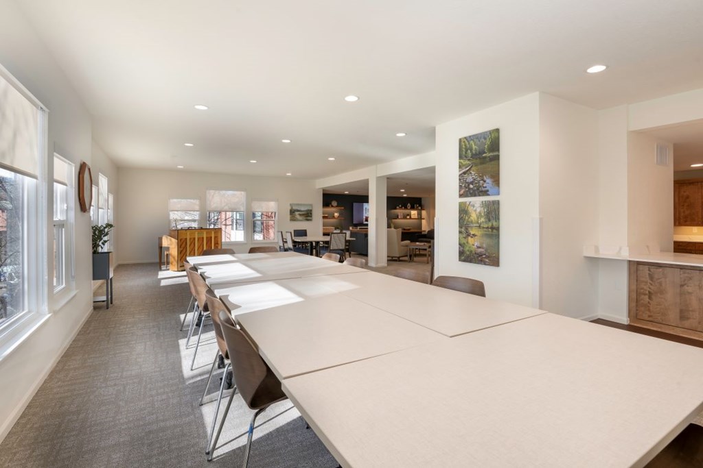 A conference room with a long table and chairs.