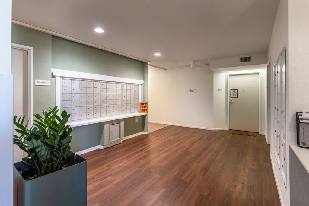A room with a wooden floor and a calendar on the wall.