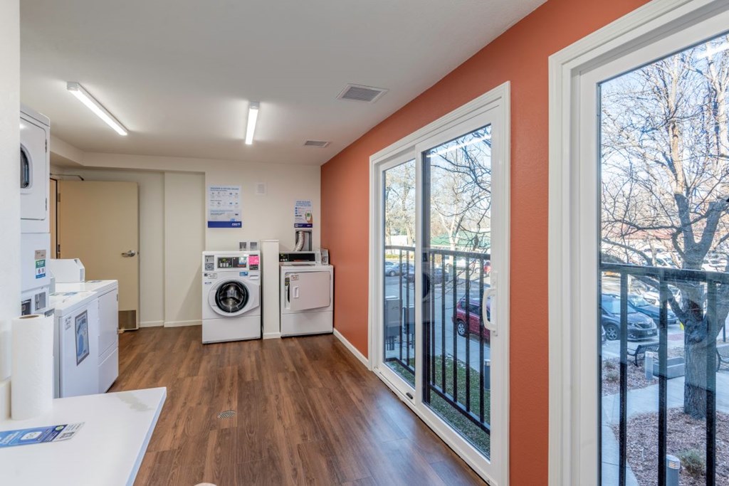 A laundry room with washer and dryer units.