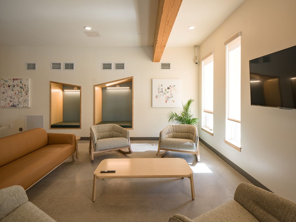 A living room with a couch, chairs, and a coffee table.