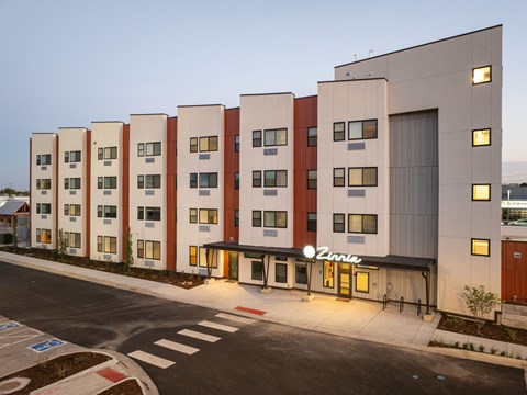 A modern building with a row of windows and a sign that says "Vina".