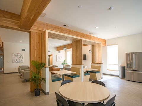 A modern dining area with a wooden table and chairs.