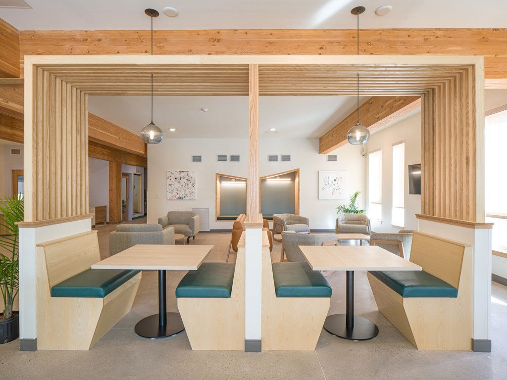 A wooden table with benches is in the middle of a room.