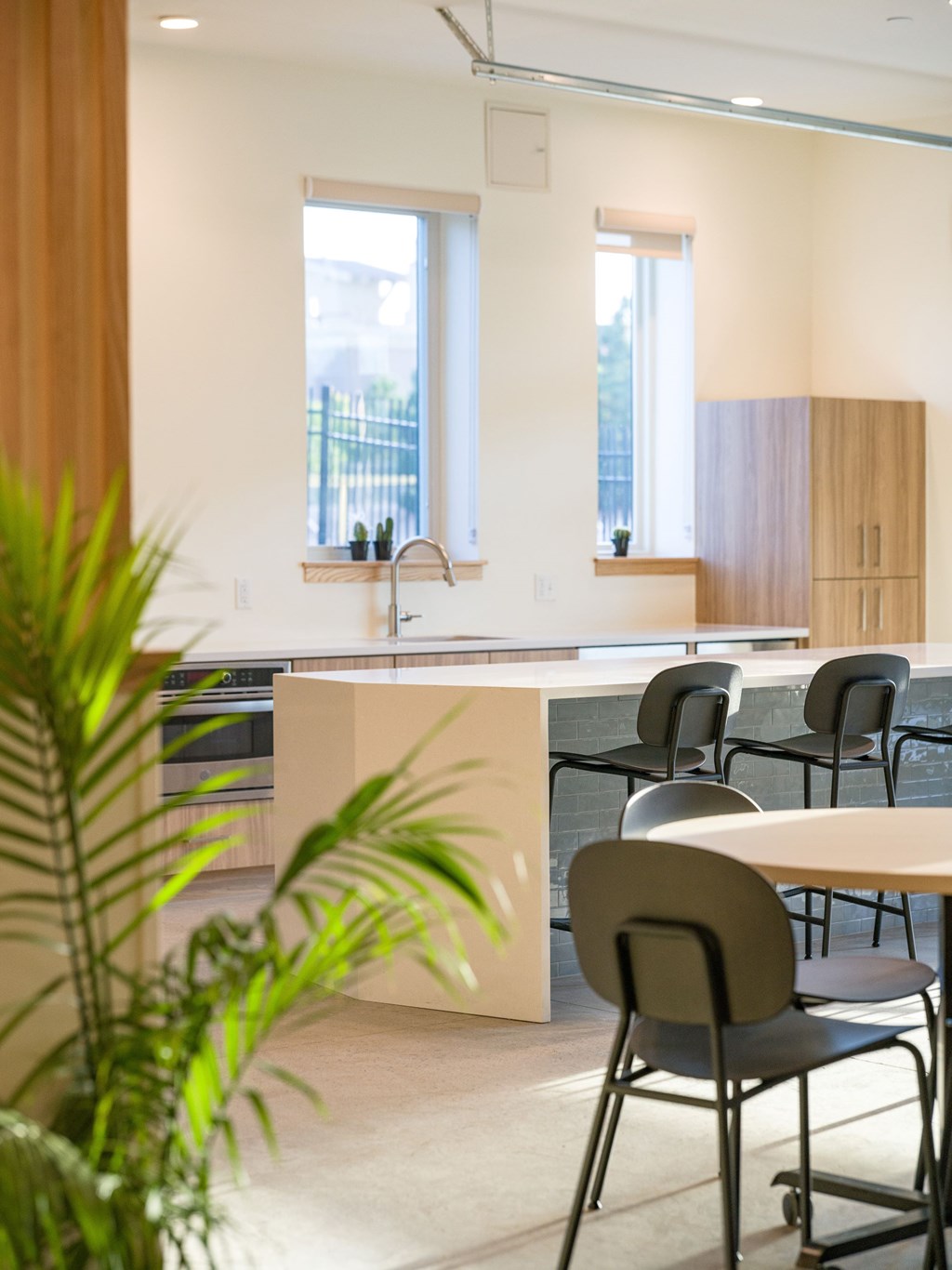 A modern kitchen with a dining table and chairs.