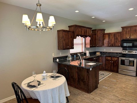 A kitchen with a table set for two.