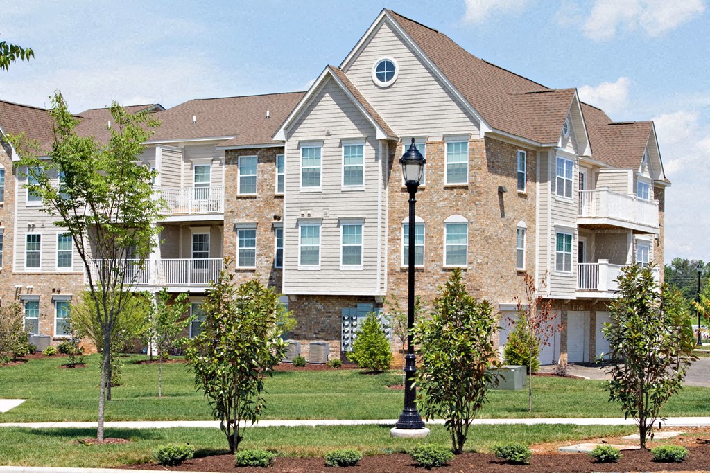 an apartment building with a street light in front of it