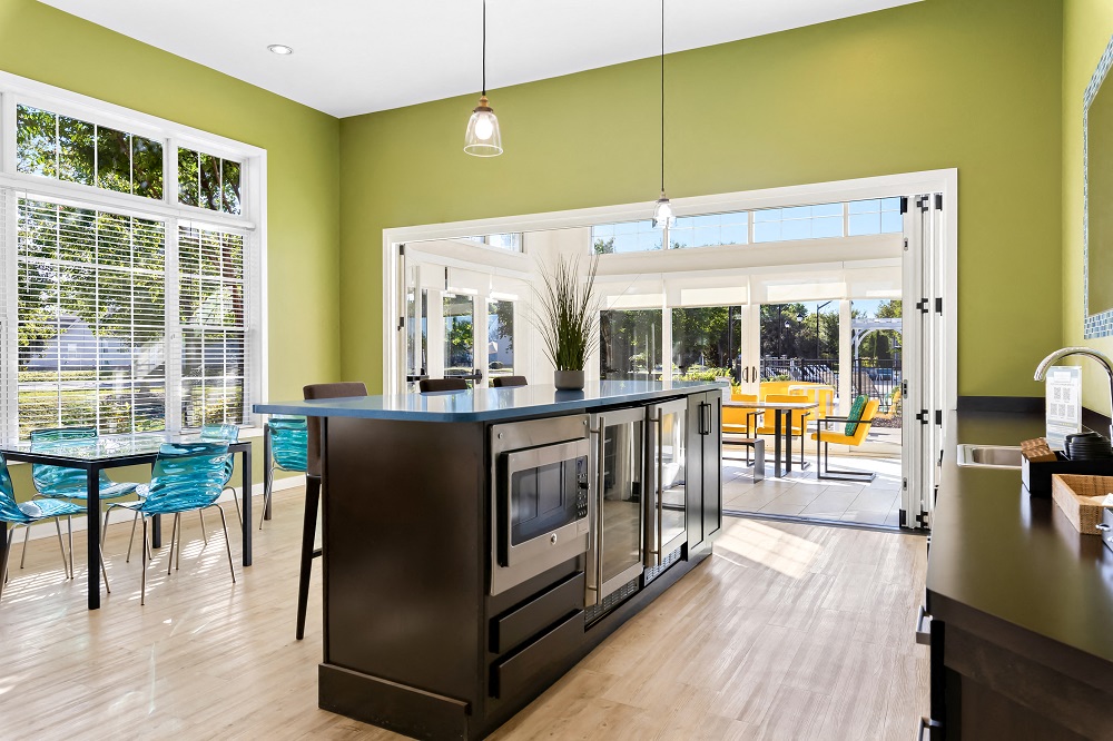 a kitchen with an island and a dining room with a table and chairs