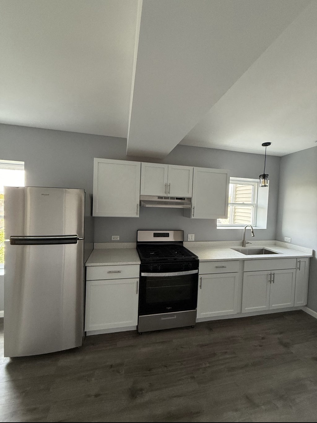 A kitchen with white cabinets and stainless steel appliances.