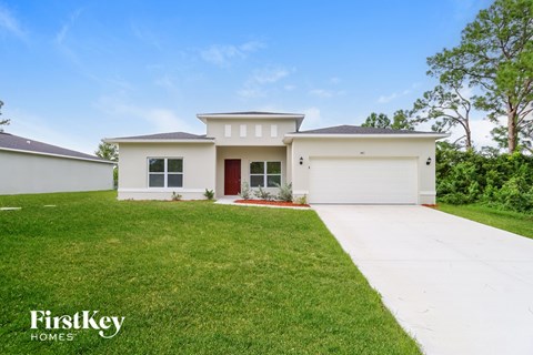 A white house with a red door is for sale by FirstKey Homes.