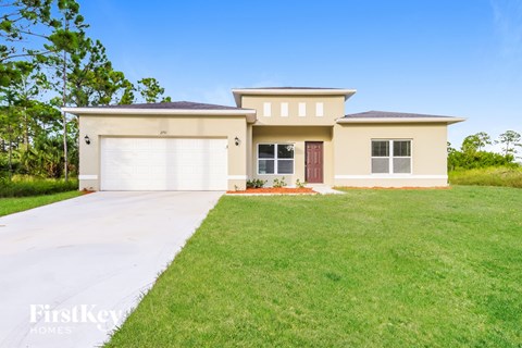 A two-story house with a garage is for sale.
